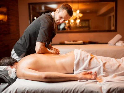masseur doing a deep massage to a male client